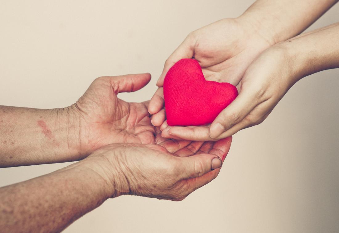 senior-woman-receiving-heart-from-women-s-hands